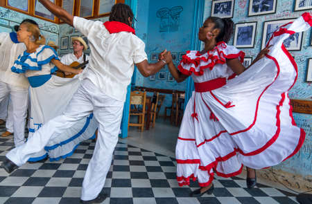 Dancers in costumes and musicians perform traditional cuban folk dance in cafe in Trinidad. Cuba, spring 2018のeditorial素材