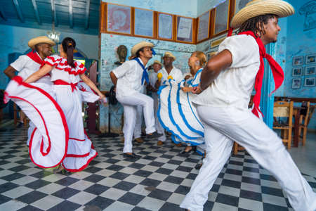 Dancers in costumes and musicians perform traditional cuban folk dance in cafe in Trinidad. Cuba, spring 2018のeditorial素材
