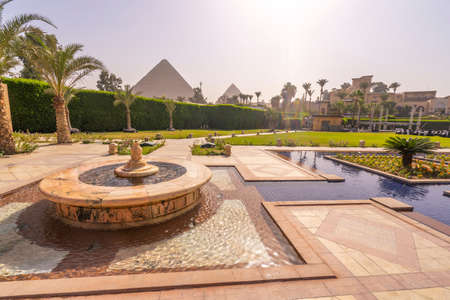 Fountain and swimming pool with Cheops pyramid in the background. Pyramids of Giza near Cairo, Egypt. Autumn 2018のeditorial素材