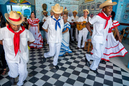 Dancers in costumes and musicians perform traditional cuban folk dance in cafe in Trinidad. Cuba, spring 2018のeditorial素材