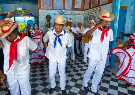 Dancers in costumes and musicians perform traditional cuban folk dance in cafe in Trinidad. Cuba, spring 2018のeditorial素材