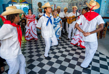 Dancers in costumes and musicians perform traditional cuban folk dance in cafe in Trinidad. Cuba, spring 2018のeditorial素材