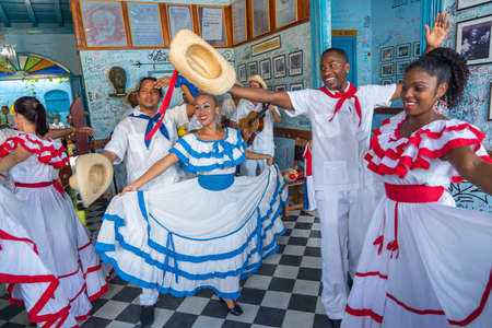 Dancers in costumes and musicians perform traditional cuban folk dance in cafe in Trinidad. Cuba, spring 2018のeditorial素材