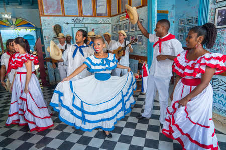 Dancers in costumes and musicians perform traditional cuban folk dance in cafe in Trinidad. Cuba, spring 2018のeditorial素材