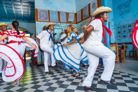 Dancers in costumes and musicians perform traditional cuban folk dance in cafe in Trinidad. Cuba, spring 2018のeditorial素材