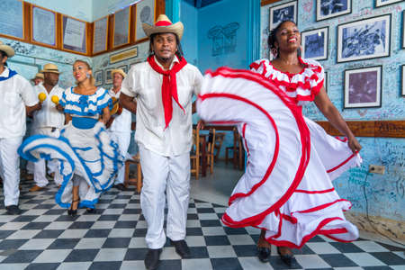 Dancers in costumes and musicians perform traditional cuban folk dance in cafe in Trinidad. Cuba, spring 2018のeditorial素材