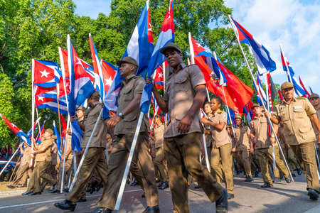 People marching with flags during May day parade or International Workers' Day, Havana, Cuba, spring 2018のeditorial素材