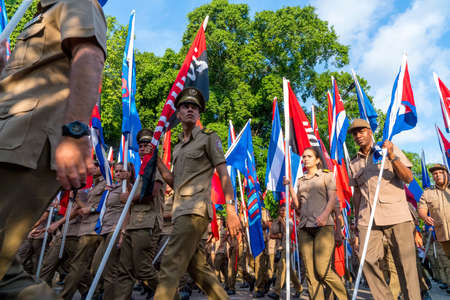 People marching with flags during May day parade or International Workers' Day, Havana, Cuba, spring 2018のeditorial素材
