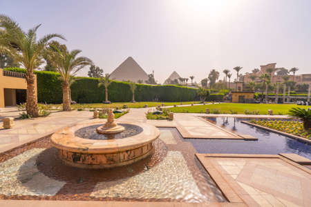 Fountain and swimming pool with Cheops pyramid in the background. Pyramids of Giza near Cairo, Egypt. Autumn 2018のeditorial素材