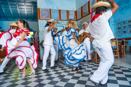 Dancers in costumes and musicians perform traditional cuban folk dance in cafe in Trinidad. Cuba, spring 2018のeditorial素材