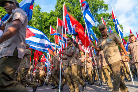 People marching with flags during May day parade or International Workers' Day, Havana, Cuba, spring 2018のeditorial素材