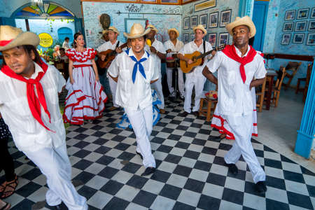 Dancers in costumes and musicians perform traditional cuban folk dance in cafe in Trinidad. Cuba, spring 2018のeditorial素材