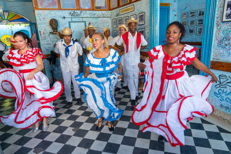 Dancers in costumes and musicians perform traditional cuban folk dance in cafe in Trinidad. Cuba, spring 2018のeditorial素材