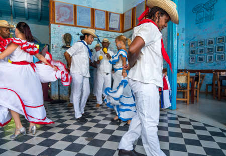 Dancers in costumes and musicians perform traditional cuban folk dance in cafe in Trinidad. Cuba, spring 2018のeditorial素材