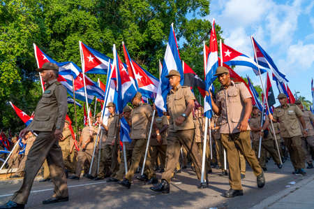 People marching with flags during May day parade or International Workers' Day, Havana, Cuba, spring 2018のeditorial素材