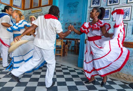 Dancers in costumes and musicians perform traditional cuban folk dance in cafe in Trinidad. Cuba, spring 2018のeditorial素材