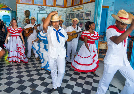 Dancers in costumes and musicians perform traditional cuban folk dance in cafe in Trinidad. Cuba, spring 2018のeditorial素材