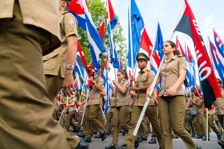 People marching with flags during May day parade or International Workers' Day, Havana, Cuba, spring 2018のeditorial素材