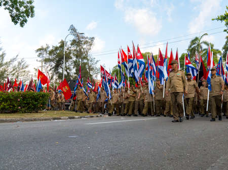 People marching with flags during May day parade or International Workers' Day, Havana, Cuba, spring 2018のeditorial素材