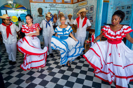 Dancers in costumes and musicians perform traditional cuban folk dance in cafe in Trinidad. Cuba, spring 2018のeditorial素材