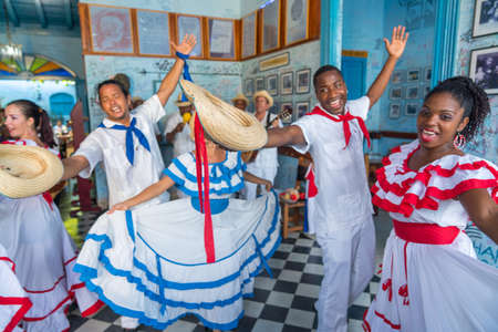 Dancers in costumes and musicians perform traditional cuban folk dance in cafe in Trinidad. Cuba, spring 2018のeditorial素材