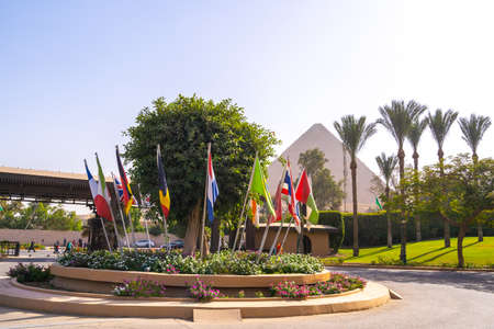 Flags of many countries and Cheops pyramid in the background. Pyramids of Giza near Cairo, Egypt. Autumn 2018のeditorial素材