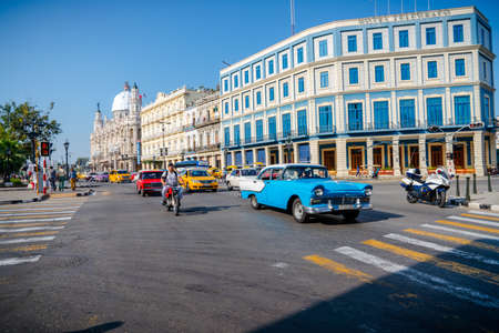 Retro car as taxi with tourists in Havana, Cuba. Captured near Gran Teatro de La Habana, El Capitolio and Paseo del Prado in spring 2019のeditorial素材
