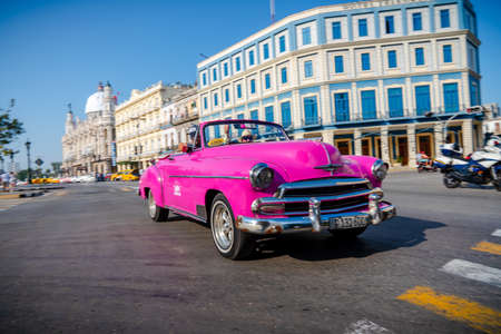 Retro car as taxi with tourists in Havana, Cuba. Captured near Gran Teatro de La Habana, El Capitolio and Paseo del Prado in spring 2019のeditorial素材