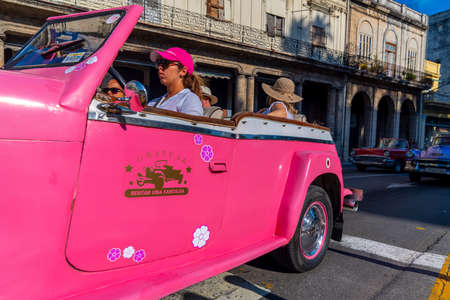 Retro car as taxi with tourists in Havana, Cuba. Captured near Paseo del Prado in spring 2019のeditorial素材