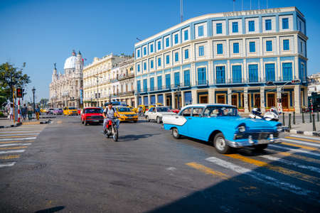 Retro car as taxi with tourists in Havana, Cuba. Captured near Gran Teatro de La Habana, El Capitolio and Paseo del Prado in spring 2019のeditorial素材
