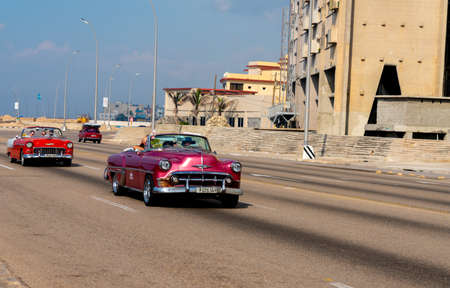 Retro taxi car with tourists in Havana, Cuba. Captured on Malecon roadway in spring 2019のeditorial素材