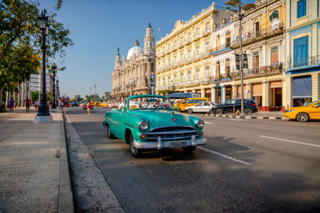 Retro car as taxi with tourists in Havana, Cuba. Captured near Gran Teatro de La Habana, El Capitolio and Paseo del Prado in spring 2019のeditorial素材