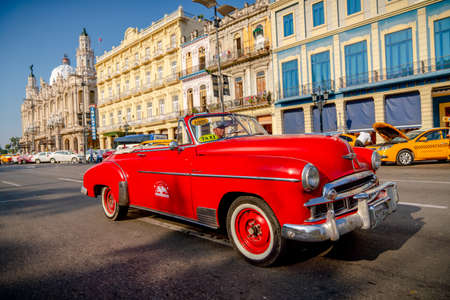 Retro car as taxi with tourists in Havana, Cuba. Captured near Gran Teatro de La Habana, El Capitolio and Paseo del Prado in spring 2019のeditorial素材
