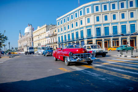 Retro car as taxi with tourists in Havana, Cuba. Captured near Gran Teatro de La Habana, El Capitolio and Paseo del Prado in spring 2019のeditorial素材