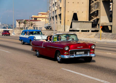 Retro taxi car with tourists in Havana, Cuba. Captured on Malecon roadway in spring 2019のeditorial素材