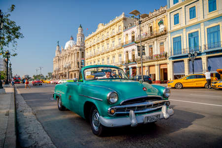 Retro car as taxi with tourists in Havana, Cuba. Captured near Gran Teatro de La Habana, El Capitolio and Paseo del Prado in spring 2019のeditorial素材