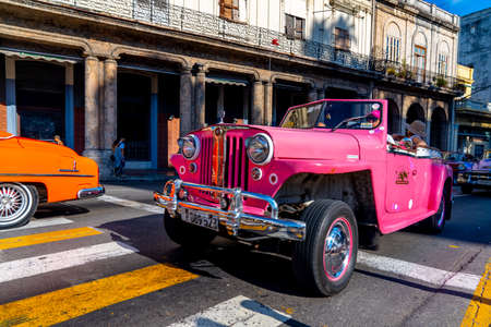 Retro car as taxi with tourists in Havana, Cuba. Captured near Paseo del Prado in spring 2019のeditorial素材