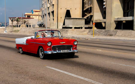 Retro taxi car with tourists in Havana, Cuba. Captured on Malecon roadway in spring 2019のeditorial素材