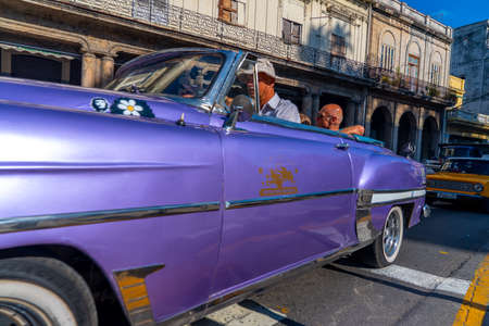 Retro car as taxi with tourists in Havana, Cuba. Captured near Paseo del Prado in spring 2019のeditorial素材