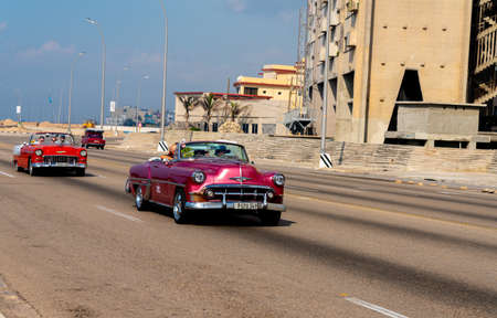 Retro taxi car with tourists in Havana, Cuba. Captured on Malecon roadway in spring 2019のeditorial素材