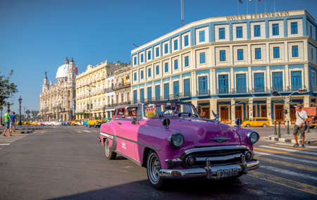 Retro car as taxi with tourists in Havana, Cuba. Captured near Gran Teatro de La Habana, El Capitolio and Paseo del Prado in spring 2019のeditorial素材