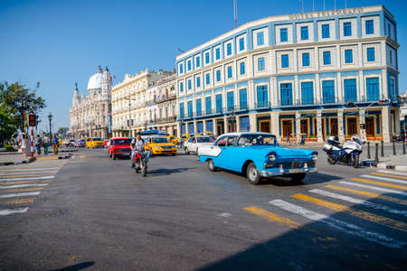 Retro car as taxi with tourists in Havana, Cuba. Captured near Gran Teatro de La Habana, El Capitolio and Paseo del Prado in spring 2019のeditorial素材