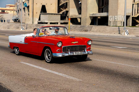 Retro taxi car with tourists in Havana, Cuba. Captured on Malecon roadway in spring 2019のeditorial素材
