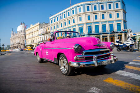 Retro car as taxi with tourists in Havana, Cuba. Captured near Gran Teatro de La Habana, El Capitolio and Paseo del Prado in spring 2019のeditorial素材