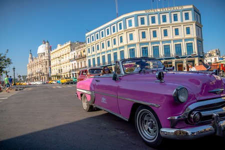 Retro car as taxi with tourists in Havana, Cuba. Captured near Gran Teatro de La Habana, El Capitolio and Paseo del Prado in spring 2019のeditorial素材