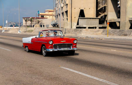 Retro taxi car with tourists in Havana, Cuba. Captured on Malecon roadway in spring 2019のeditorial素材