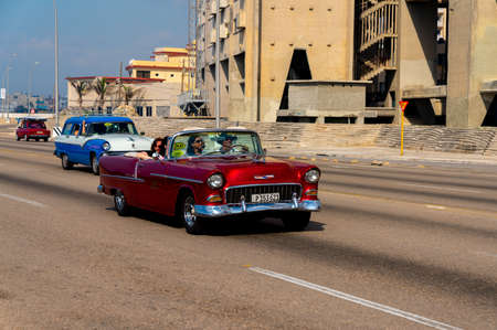 Retro taxi car with tourists in Havana, Cuba. Captured on Malecon roadway in spring 2019のeditorial素材