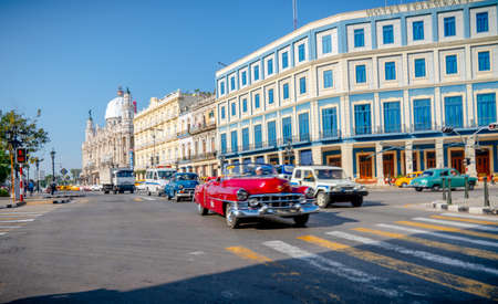 Retro car as taxi with tourists in Havana, Cuba. Captured near Gran Teatro de La Habana, El Capitolio and Paseo del Prado in spring 2019のeditorial素材