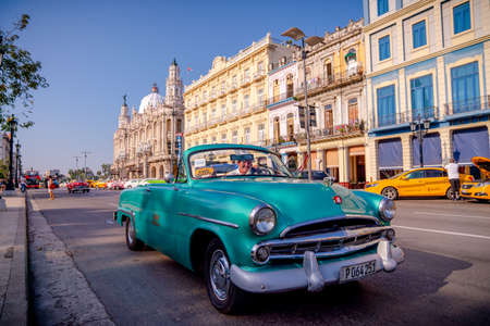 Retro car as taxi with tourists in Havana, Cuba. Captured near Gran Teatro de La Habana, El Capitolio and Paseo del Prado in spring 2019のeditorial素材