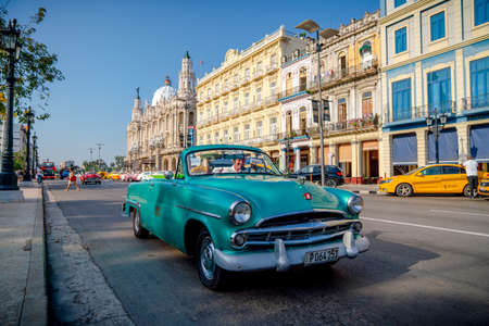 Retro car as taxi with tourists in Havana, Cuba. Captured near Gran Teatro de La Habana, El Capitolio and Paseo del Prado in spring 2019のeditorial素材